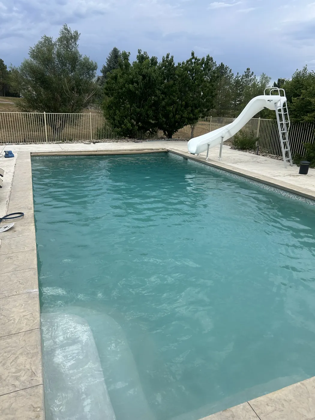 After: clear pool with slide following a Pyle's recovery in Aurora, CO