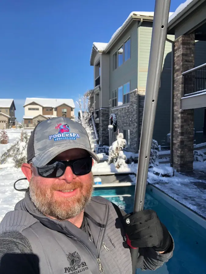 Joel Pyle, CPO-certified owner of Pyle's Pool & Spa Specialists, working poolside in winter snow