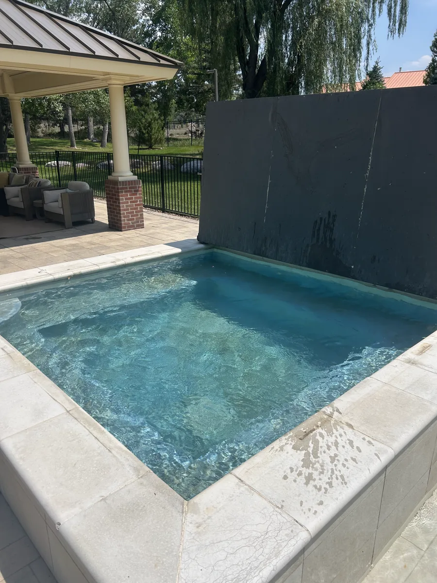 Estate pool with covered cabana and water feature serviced in Greenwood Village, CO